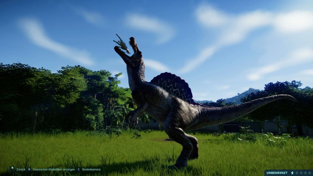 Ein Fleischfresser mampft eine Ziege im Spiel Jurassic World Evolution.