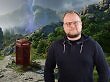 Redakteur Carlo Siebenhüner vor dem Titelbild des Spiels