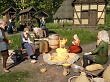 Bild aus Medieval Frontiers zeigt Charaktere am Lagerfeuer