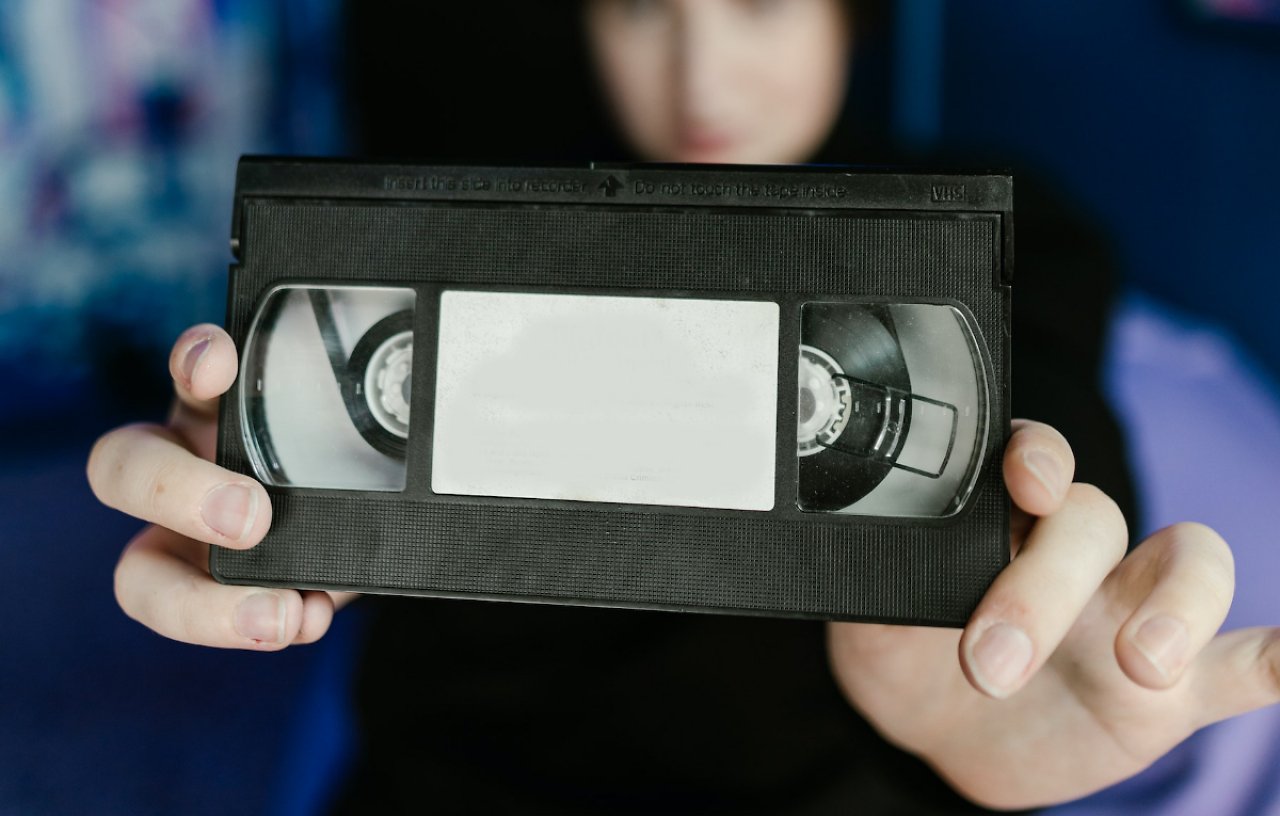 Eine VHS-Kassette wird ins Bild gehalten.