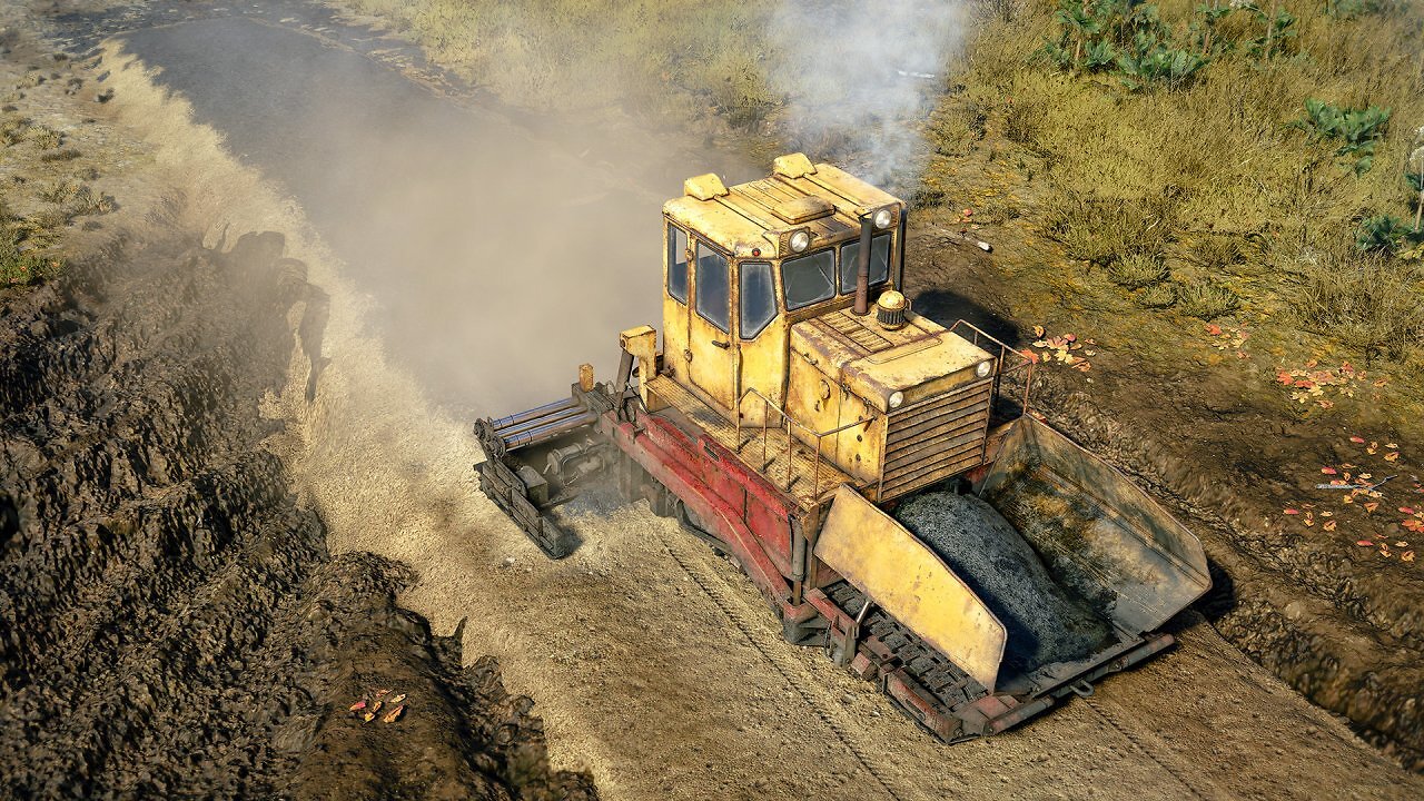 Eine Maschine legt Asphalt auf Sand