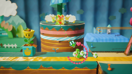Yoshi's Crafted World: Welt 2 - Level 1: Schnuffel auf der Rolle: In diesem Geschenk im Hintergrund befinden sich rote Münzen - abschießen!